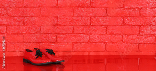 red womens shoes, red brick wall background © serikbaib