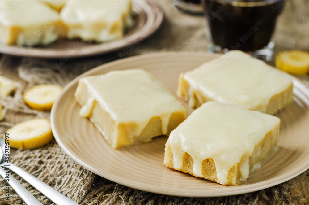 White chocolate banana bars in a plate with glasses of coffee