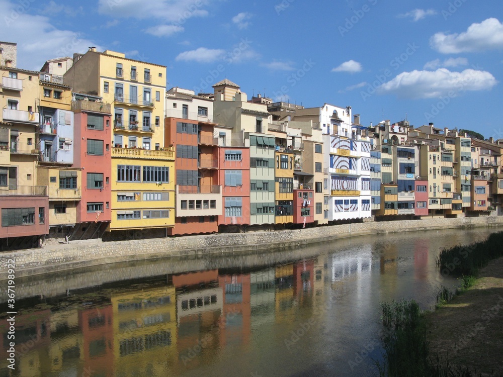 Cityscape with colorful houses and their reflection in the waters of the Onyar river in Girona, Catalunya, Spain