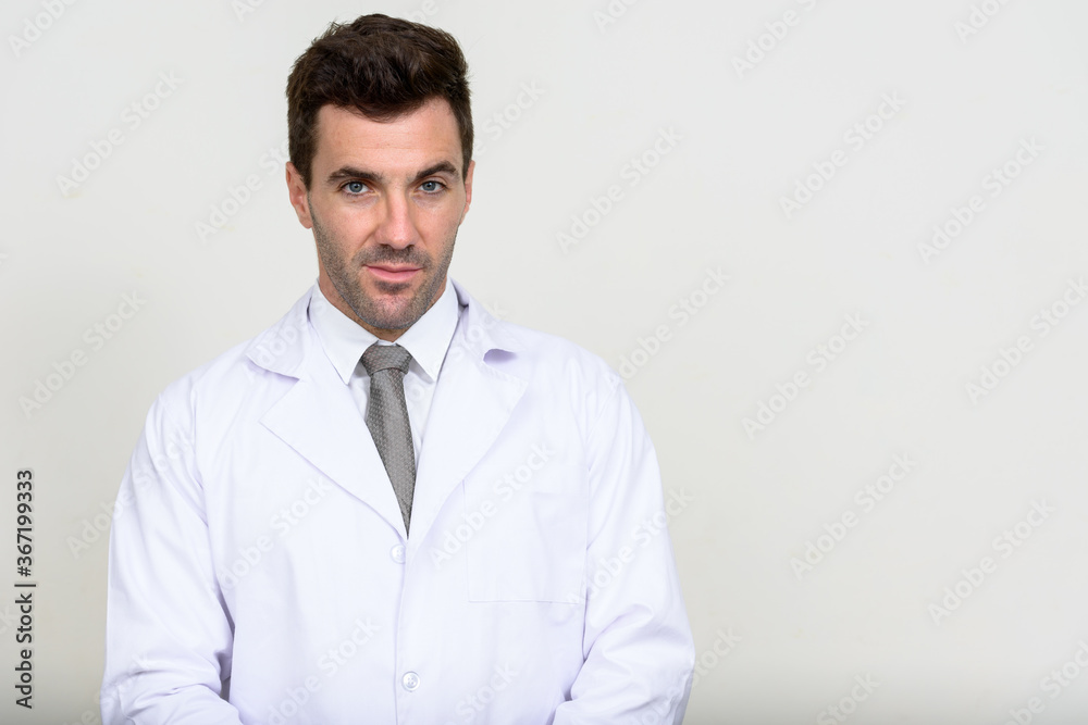 Portrait of handsome Hispanic man doctor looking at camera Portrait of handsome Hispanic man doctor looking at camera