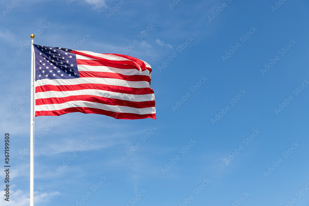 Beautiful American flag waving in the wind, with vibrant red white and