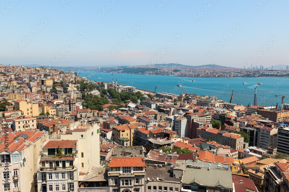 Aerial city view of Istanbul from Galata tower, old houses in Beyoglu district and Golden Horn landscape.