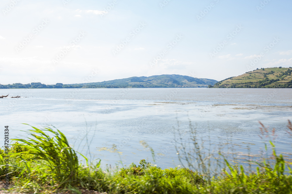 Beautiful river landscape on summer day with blue sky