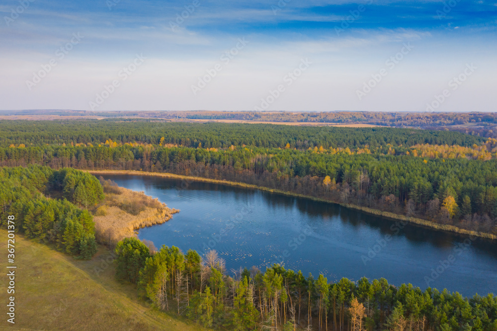 Lake with blue water view from the top. Autumn lake shot from a quadrocopter. Lake in the forest Lake with blue water view from the top. Autumn lake shot from a quadrocopter. Lake in the forest