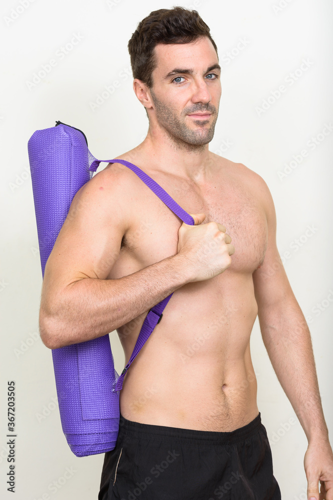 Portrait of handsome shirtless Hispanic man ready for gym