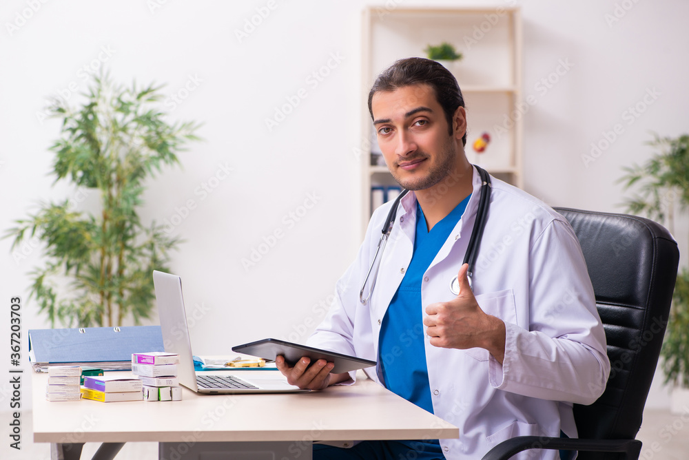 Young male doctor in telemedicine concept Young male doctor in telemedicine concept