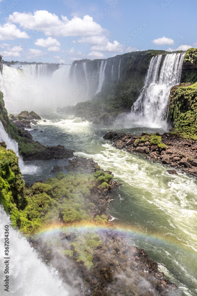 Obraz premium Rainbow, forest, waterfalls and river with rocks