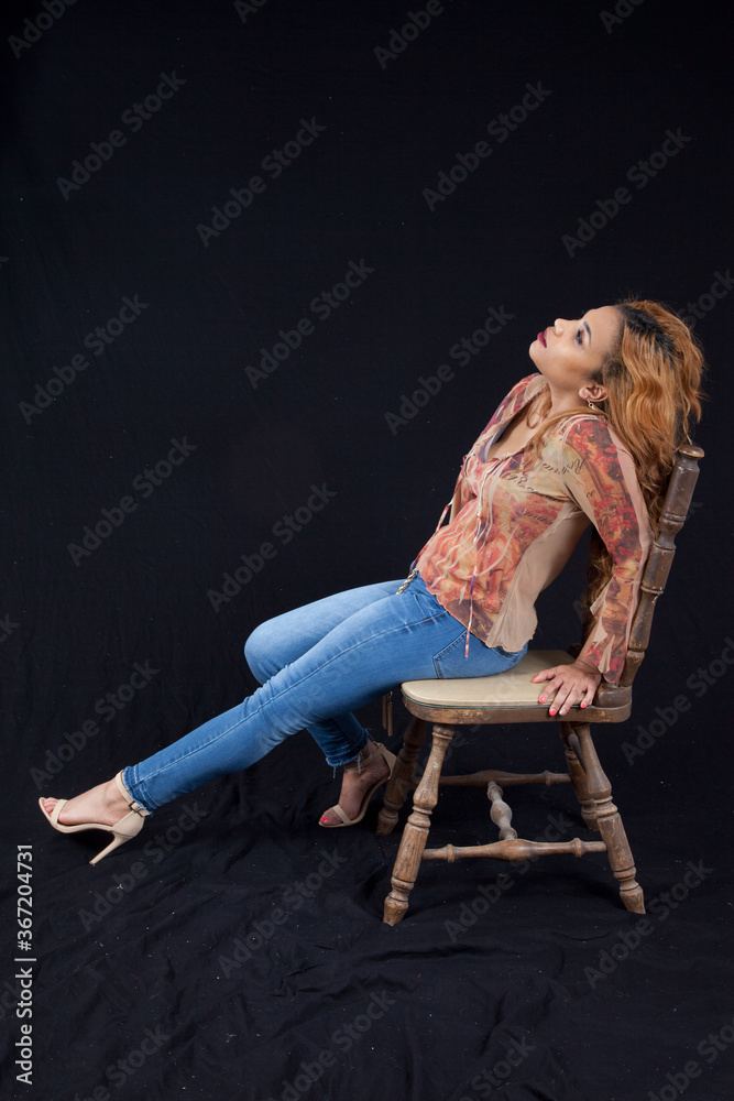 Lovely Hispanic woman relaxing in a chiar