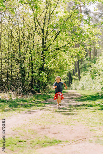 Girl running on trail in forest © amelie