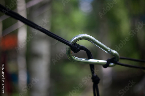 The carabiner secures the rope.