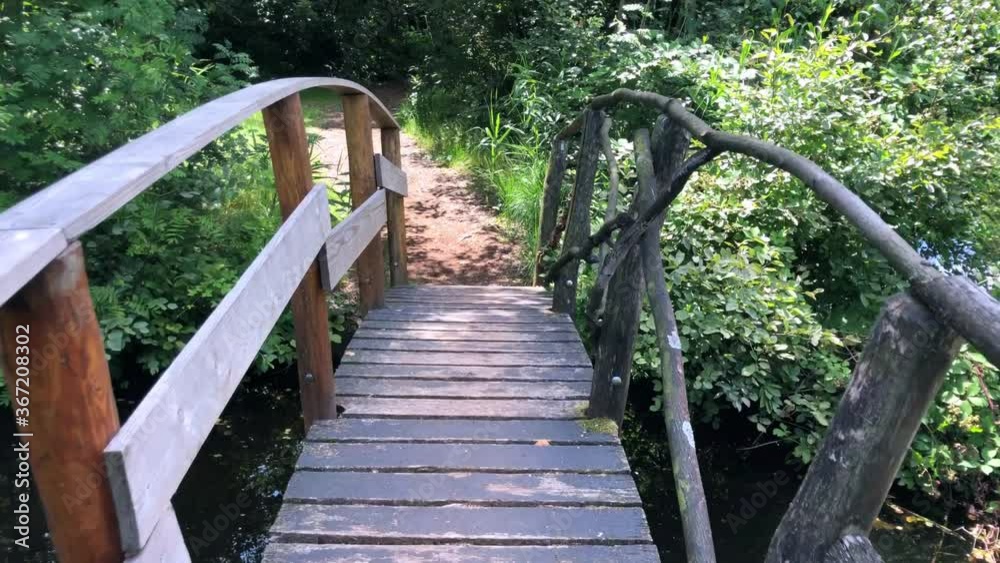 hiking route with small bridge through the tall grass in Lusthof de Haeck at the Nieuwkoopse Plassen hiking route with small bridge through the tall grass in Lusthof de Haeck at the Nieuwkoopse Plassen