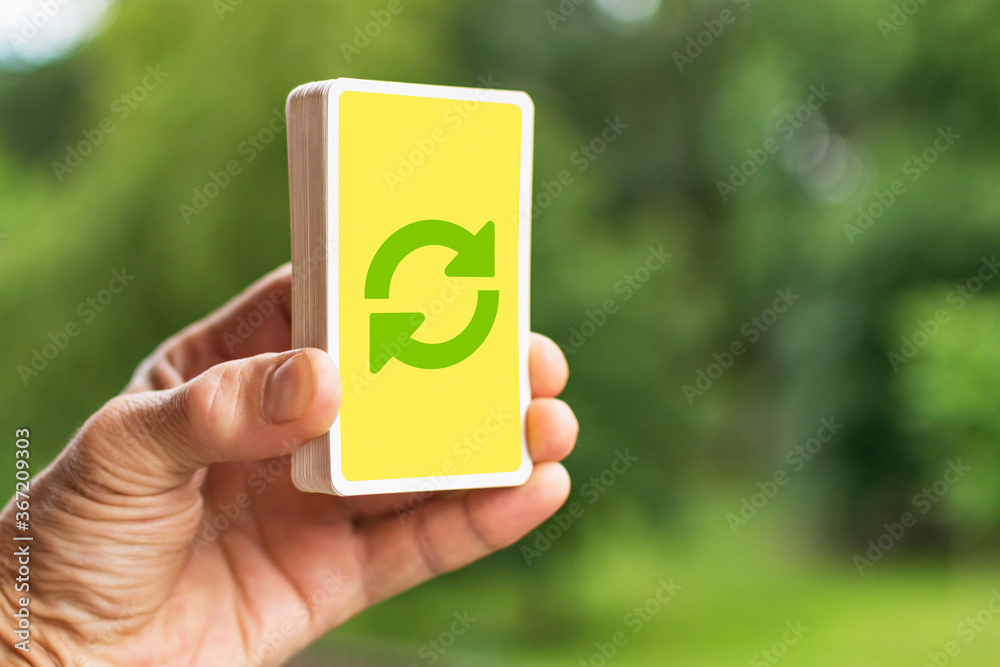 A man holds a deck of cards in his hand