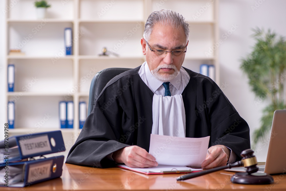 Old male judge working in courthouse Old male judge working in courthouse