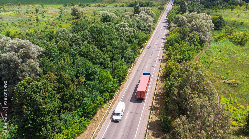Aerial. Countryside highway traffic with truck and lorry. Top view from drone.