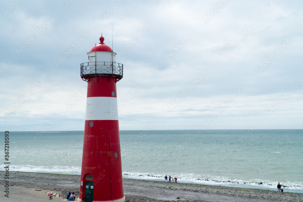 Lighthouse near a rock beach overlooking the NorthSea, shot in Westkapelle 