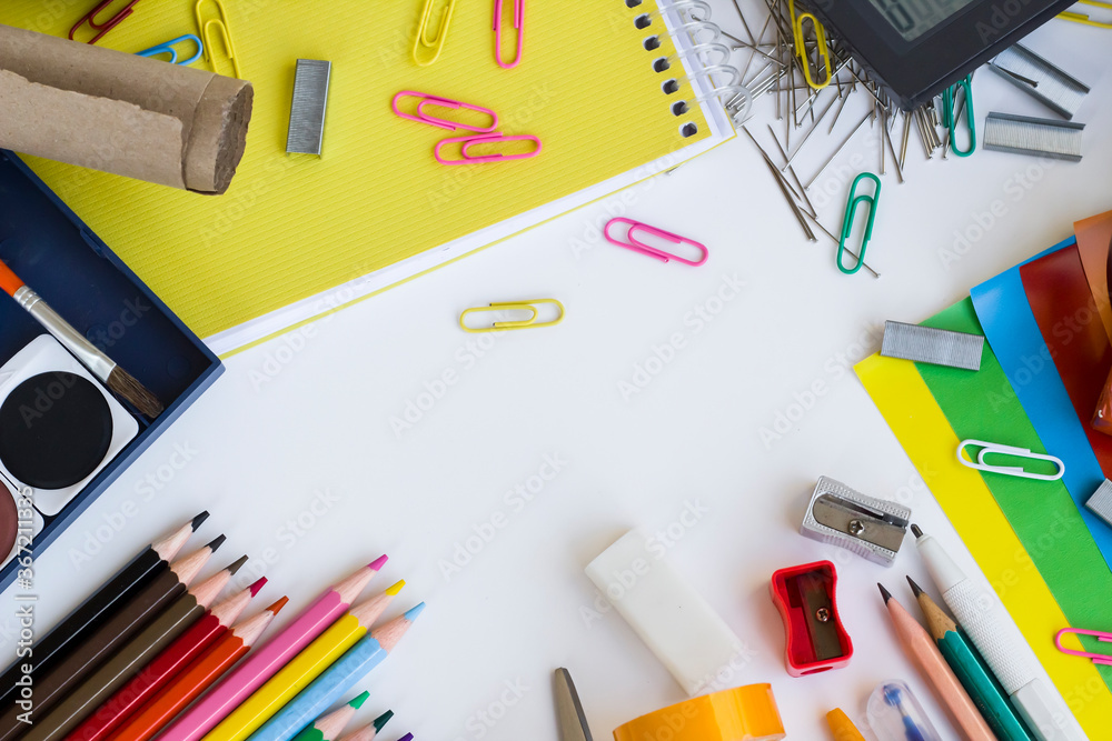 Colorful school supplies on white surface with copy space,Able to use vertical or horizontal way. Colorful school supplies on white surface with copy space,Able to use vertical or horizontal way.