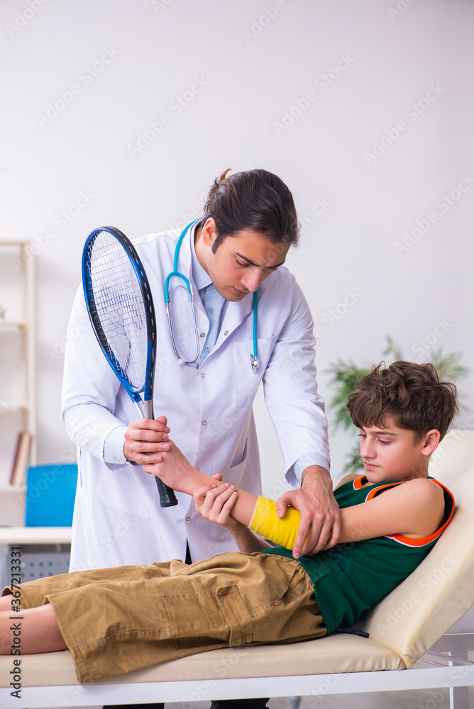 Sick boy visiting young male doctor pediatrician