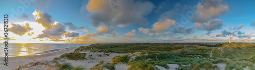 Fotografia, Obraz Panoramic view of Lyngvig lighthouse on wide dune of Holmsland Klit with beach v
