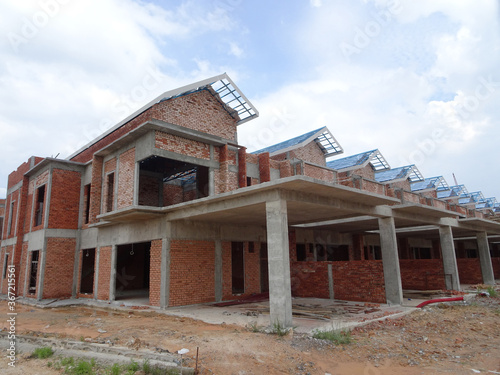 SEREMBAN, MALAYSIA -APRIL 07, 2020: New double story luxury terrace house under construction in Malaysia.  Designed by an architect with a modern and contemporary style.  © Aisyaqilumar
