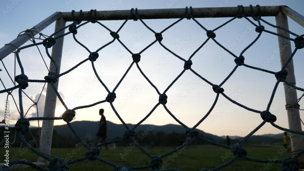 silhouette children play football with mountain background selective focus. silhouette children play football with mountain background selective focus.