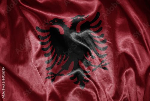 colorful shining big national flag of albania on a silky texture.