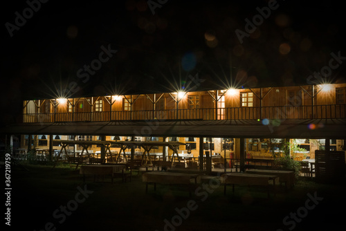 Two-storey motel made of wood in at night. Farm homes. Plateau tourism. Daday, Kastamonu, Turkey. photo