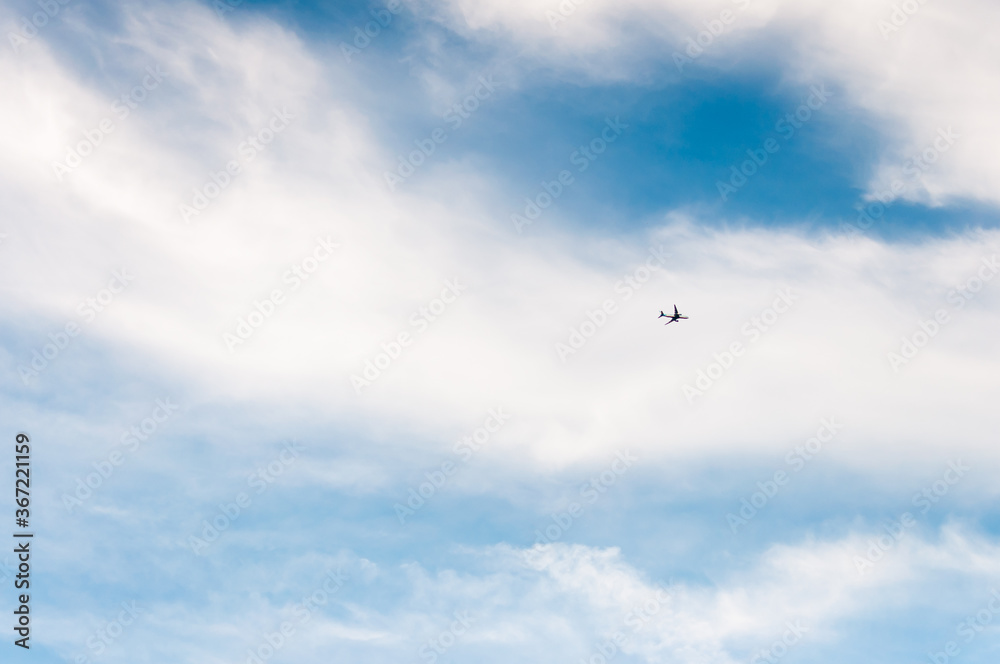 High blue sky with feathery clouds. The sky is a symbol of vastness, freedom, and air.