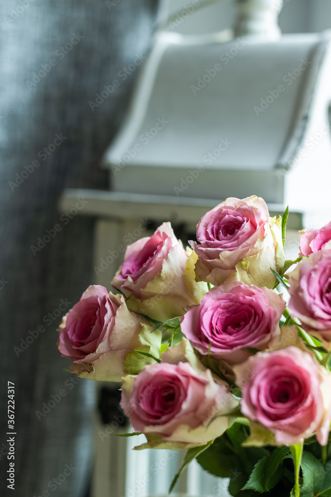 Bouquet of roses on the windowsill next to the lantern Bouquet of roses on the windowsill next to the lantern