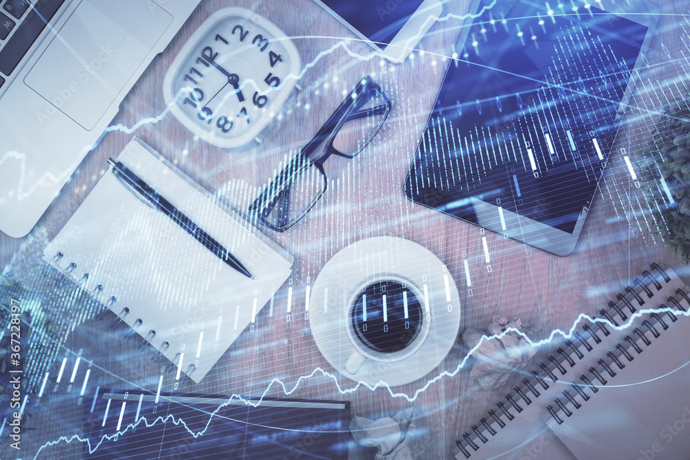 Double exposure of financial chart hologram over desktop with phone. Top view. Mobile trade platform concept.