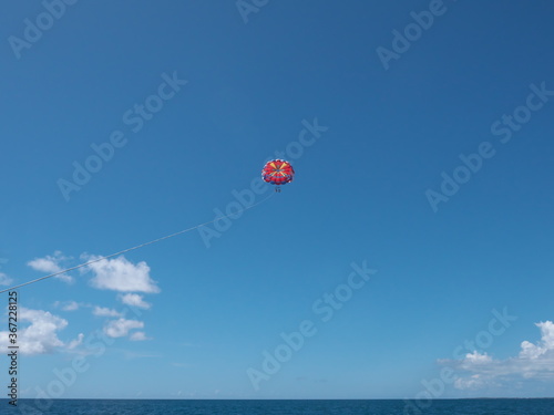 Okinawa,Japan-July 20, 2020: Parasailing on blue sky background at Miyakojima island
