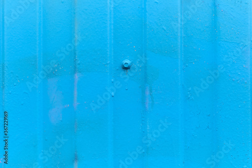 Metallic siding as a blue background. Close up.
