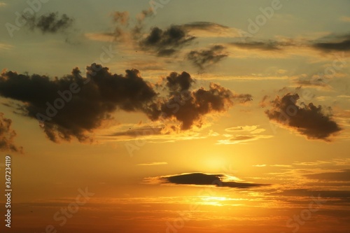Fototapeta Naklejka Na Ścianę i Meble -  Beautiful golden fiery sunset with dark clouds, natural background 