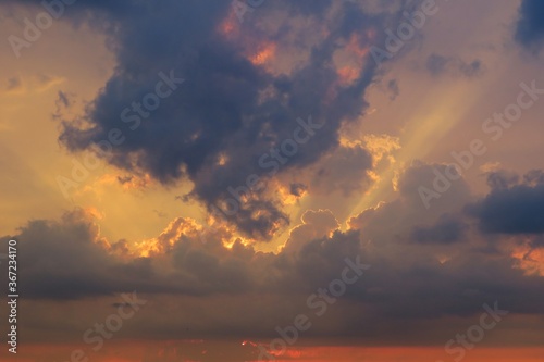 Beautiful dark dramatic clouds in the sky at sunset, natural background