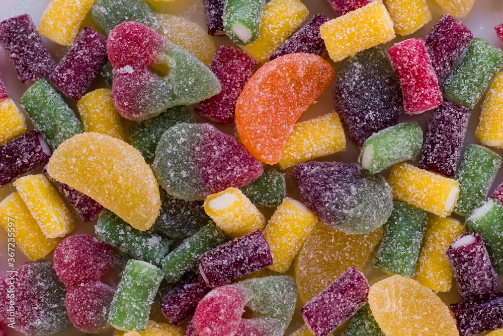 Colorful jelly candies background,on white surface,close up taken. Colorful jelly candies background,on white surface,close up taken.