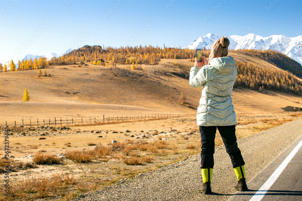 Woman Enjoying Landscape Of Autumn Mountains. Woman Hiker Taking Photo With Smart Phone.