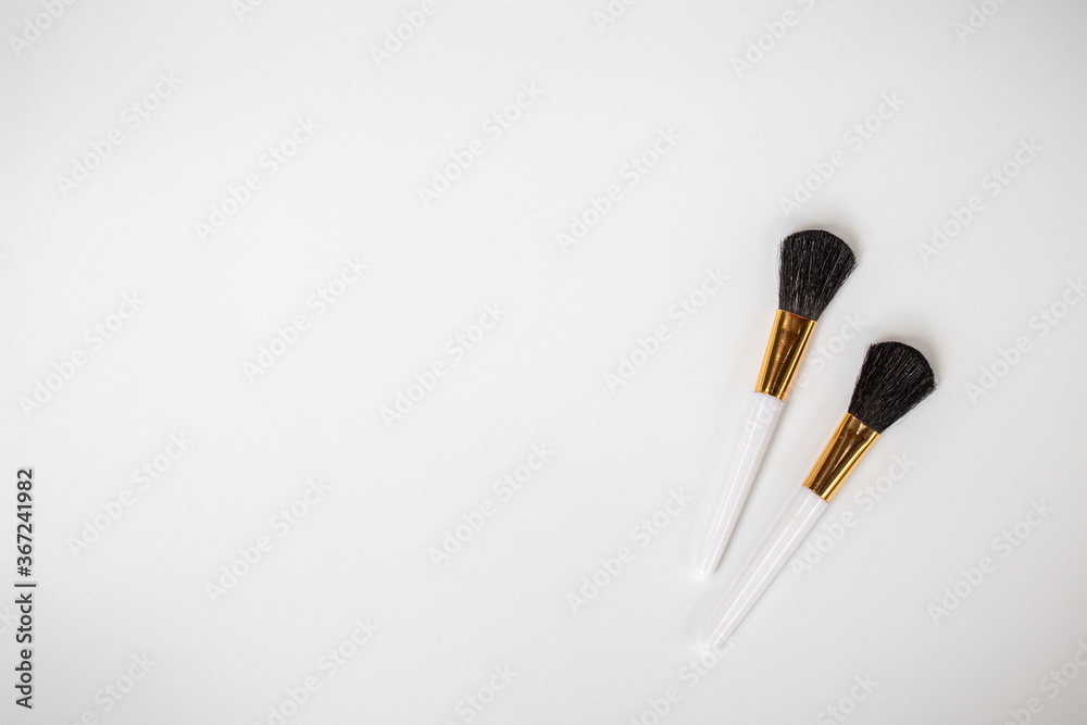 Make up brushes with powder on white background Make up brushes with powder on white background