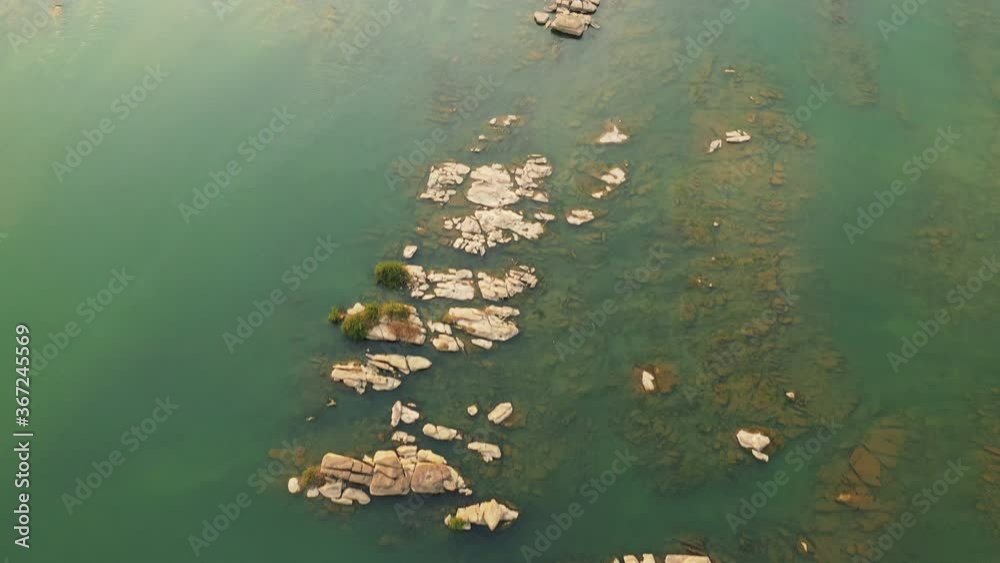 The rocky islands in the middle of the Mekong in Asia, Laos, Champasak, on a sunny day. The rocky islands in the middle of the Mekong in Asia, Laos, Champasak, on a sunny day.
