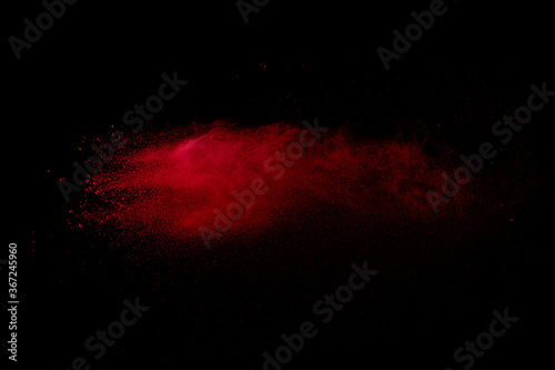 Red powder explosion on black background. 
