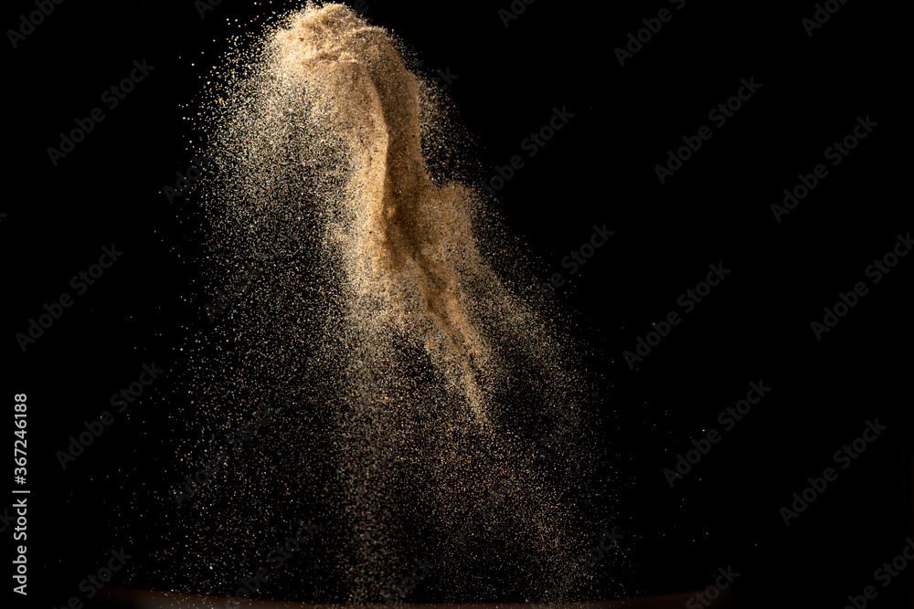 Gold sand explosion isolated on black background. Abstract sand cloud. - obrazy, fototapety, plakaty 