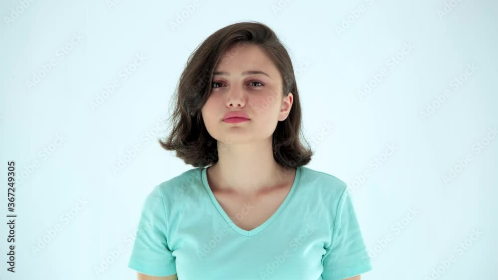 Young attractive womand looking disapprovingly at camera and showing thumbs down. Young attractive womand looking disapprovingly at camera and showing thumbs down.