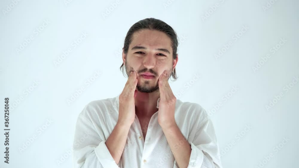 Portrait of sick young man having strong toothache, holding his cheeks with hands isolated over white background in studio. Concept of dental problems, Tooth decay. Portrait of sick young man having strong toothache, holding his cheeks with hands isolated over white background in studio. Concept of dental problems, Tooth decay.