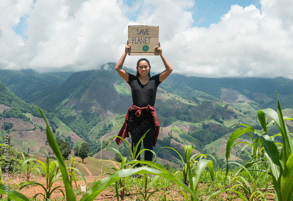 Young woman holding "Save the planet" Poster showing a sign protesting ...