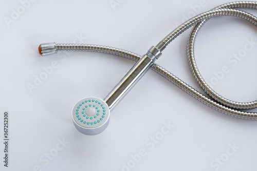 New,unused stainless steel of shower head and apparatus on white surface,top view
