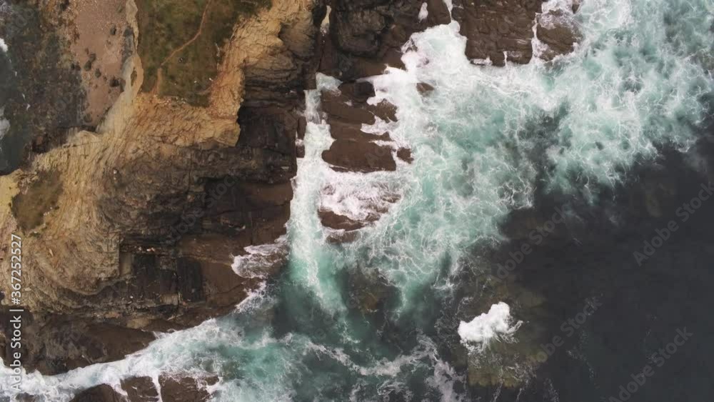 Beautiful Coastline view and waves crashing on rocky cliff shoreline. Aerial Drone Video Beautiful Coastline view and waves crashing on rocky cliff shoreline. Aerial Drone Video