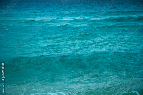 Natural water texture. Turquoise color water ocean and sea waves in the Caribbean. Relaxing pattern and tones.