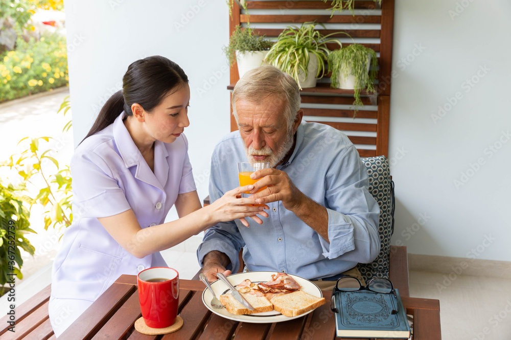 Nurse assist senior man having breakfast together Nurse assist senior man having breakfast together