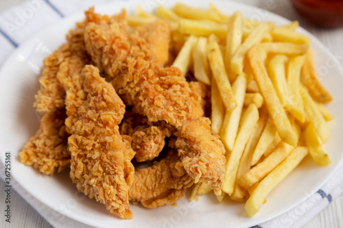 Homemade Crispy Chicken Tenders and French Fries, low angle view. Close-up.