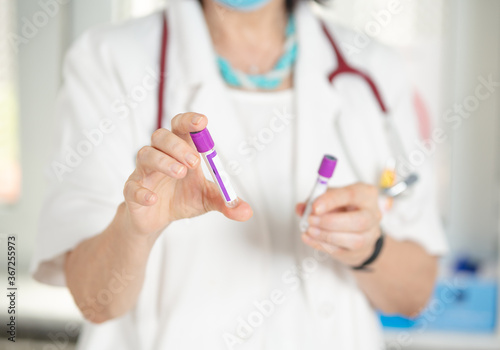 Woman doctor holding test tube.