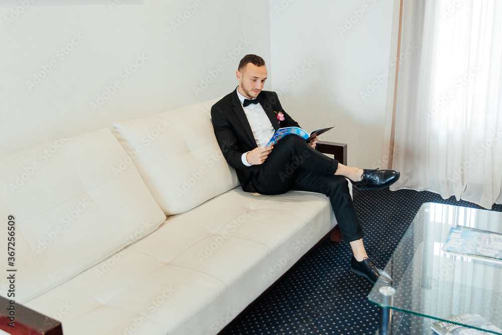 Portraits of the groom at the hotel training camp, dressed as a businessman in a black suit, tuxedo and white shirt Portraits of the groom at the hotel training camp, dressed as a businessman in a black suit, tuxedo and white shirt