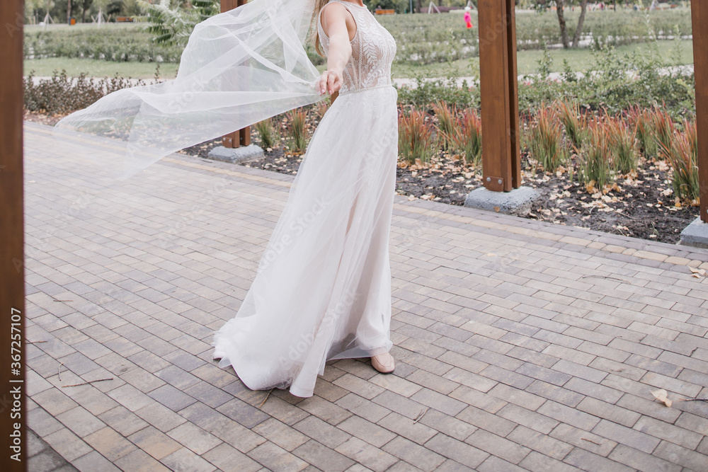bride with flying veil in the park bride with flying veil in the park